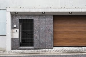 Elegancka przestrzeń wejściowa z bramą drewnianą i prostym ogrodzeniem – idealne miejsce na montaż napędu do bramy skrzydłowej FAAC, zapewniającego wygodę i płynne działanie.