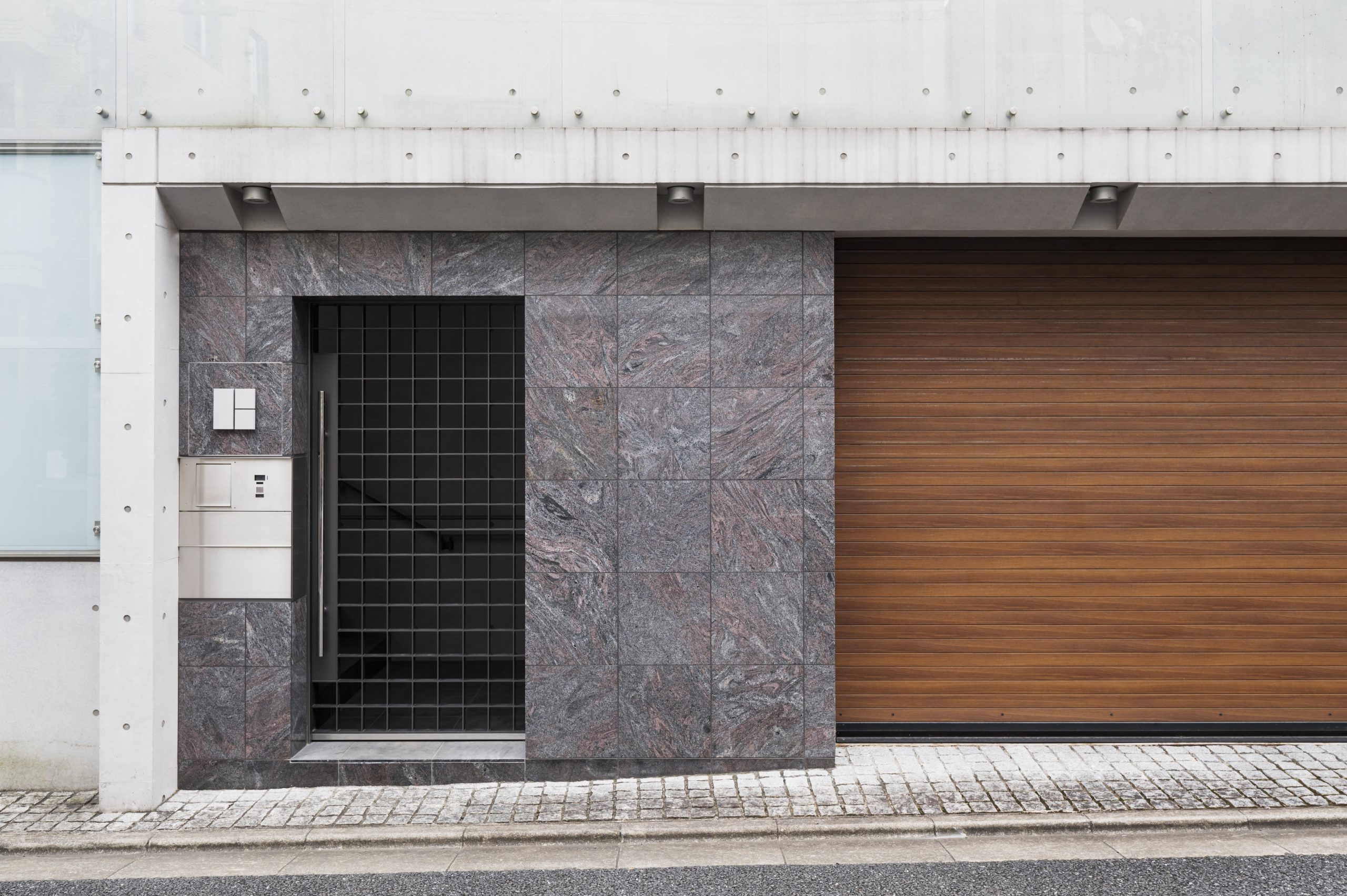 Elegancka przestrzeń wejściowa z bramą drewnianą i prostym ogrodzeniem – idealne miejsce na montaż napędu do bramy skrzydłowej FAAC, zapewniającego wygodę i płynne działanie.